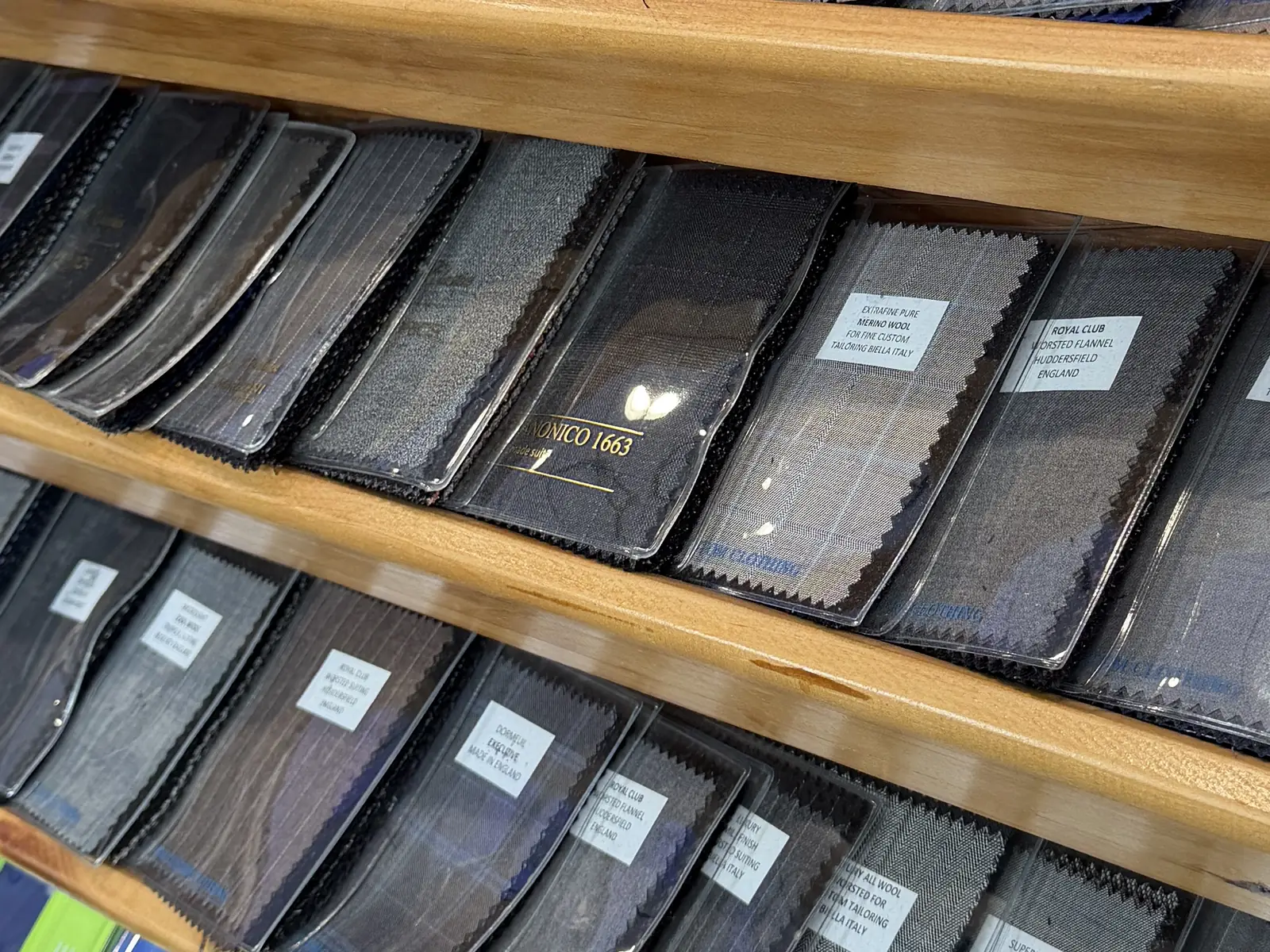 Close view of suiting swatch books with their fabric labels