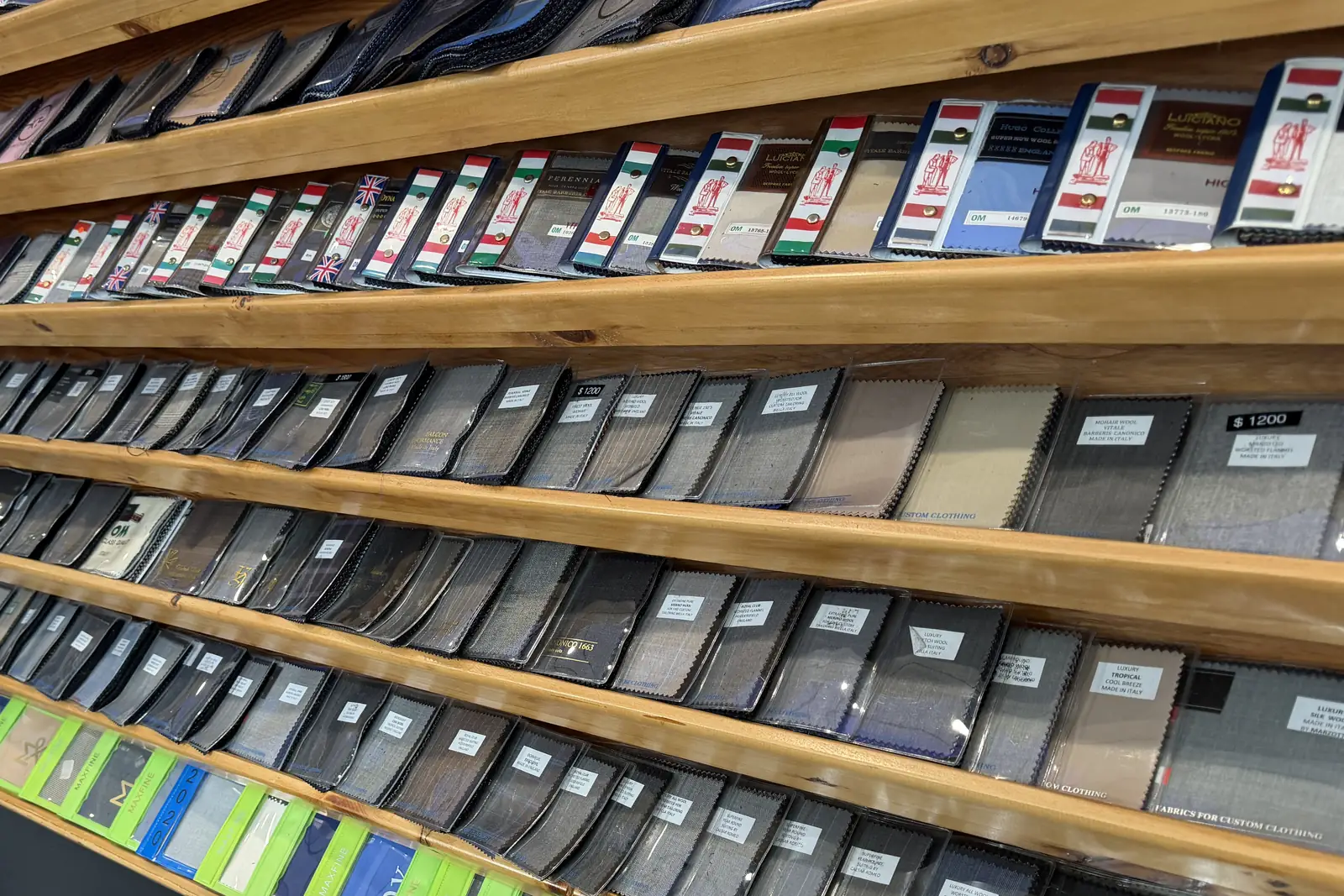 The wall of suiting fabric books at Komal's Suits